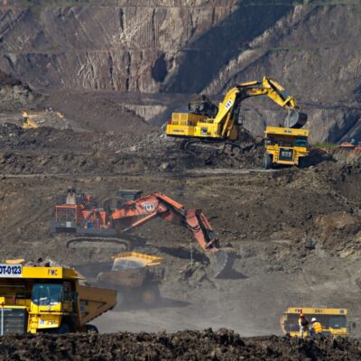 Large earth movers and mining trucks in a quarry