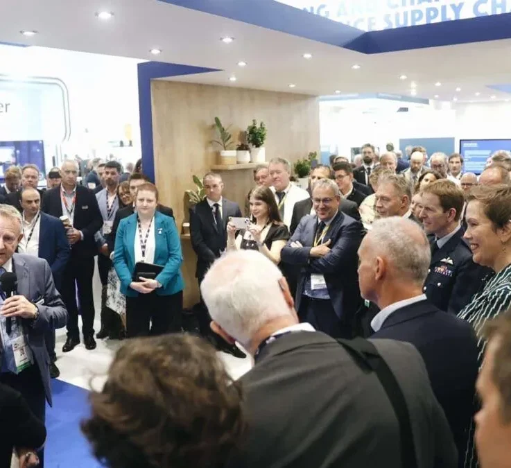 Group of men and women listening to someone being interviewed